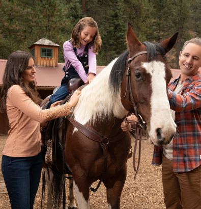 A Group Of People Standing Next To A Horse