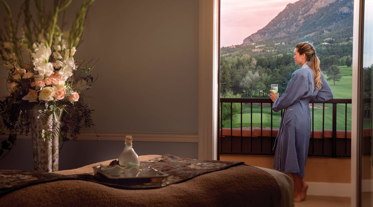 Woman looking out balcony after massage at The Broadmoor 