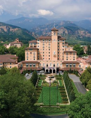 A View Of A Large Building With A Mountain In The Background