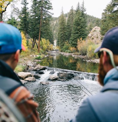 A Group Of People Standing In A River