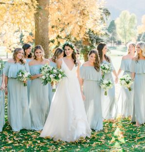 Bride and bridesmaids walking on sunny fall day