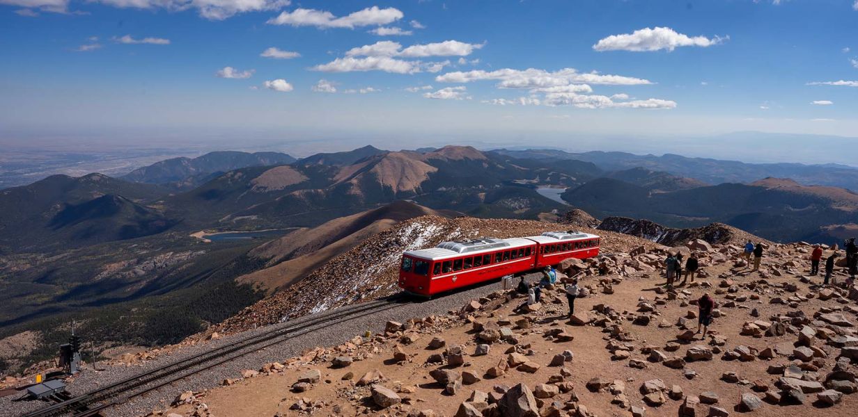 A Red Train On A Rocky Hill